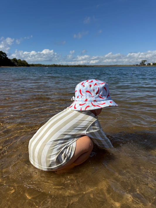 child playing outdoors wearing UPF sun protective clothing