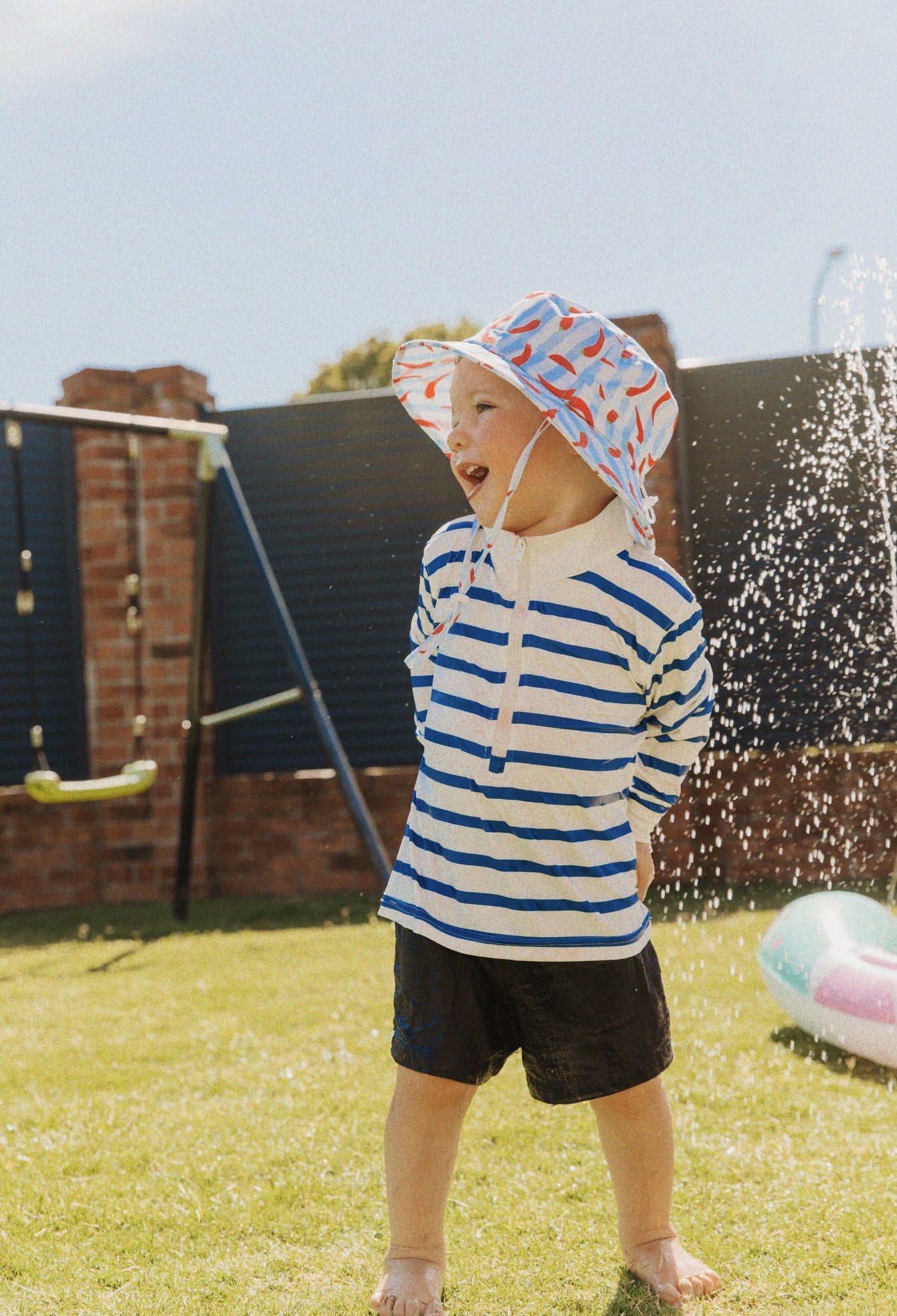 Child wearing Holiday Club Mini kids UPF 50+ sunwear shirt outdoors