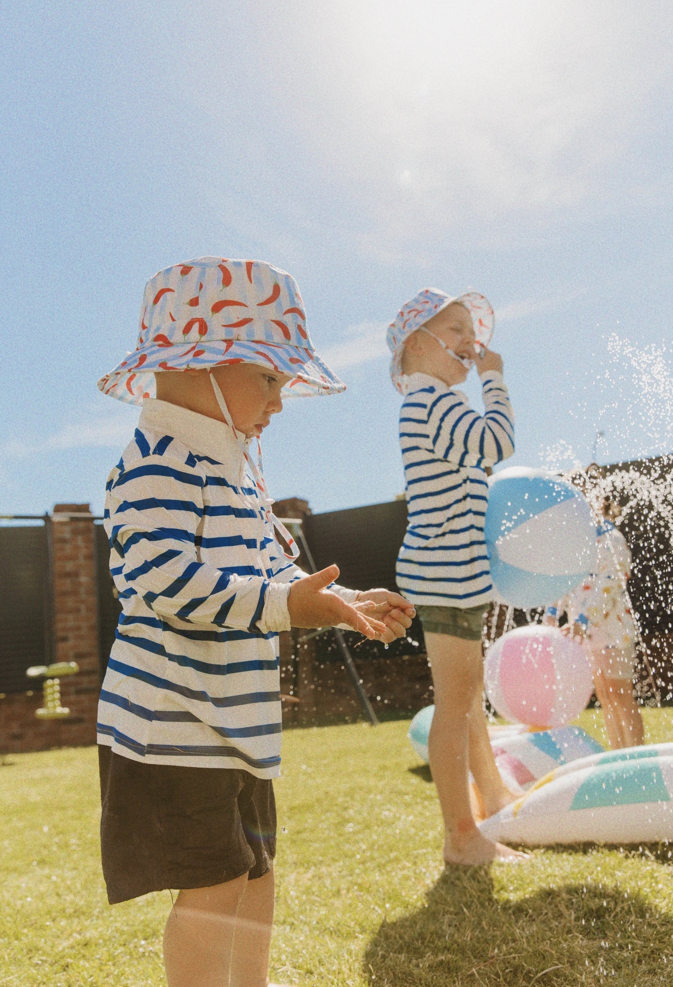 Child wearing Holiday Club Mini kids UPF 50+ sunwear shirt outdoors