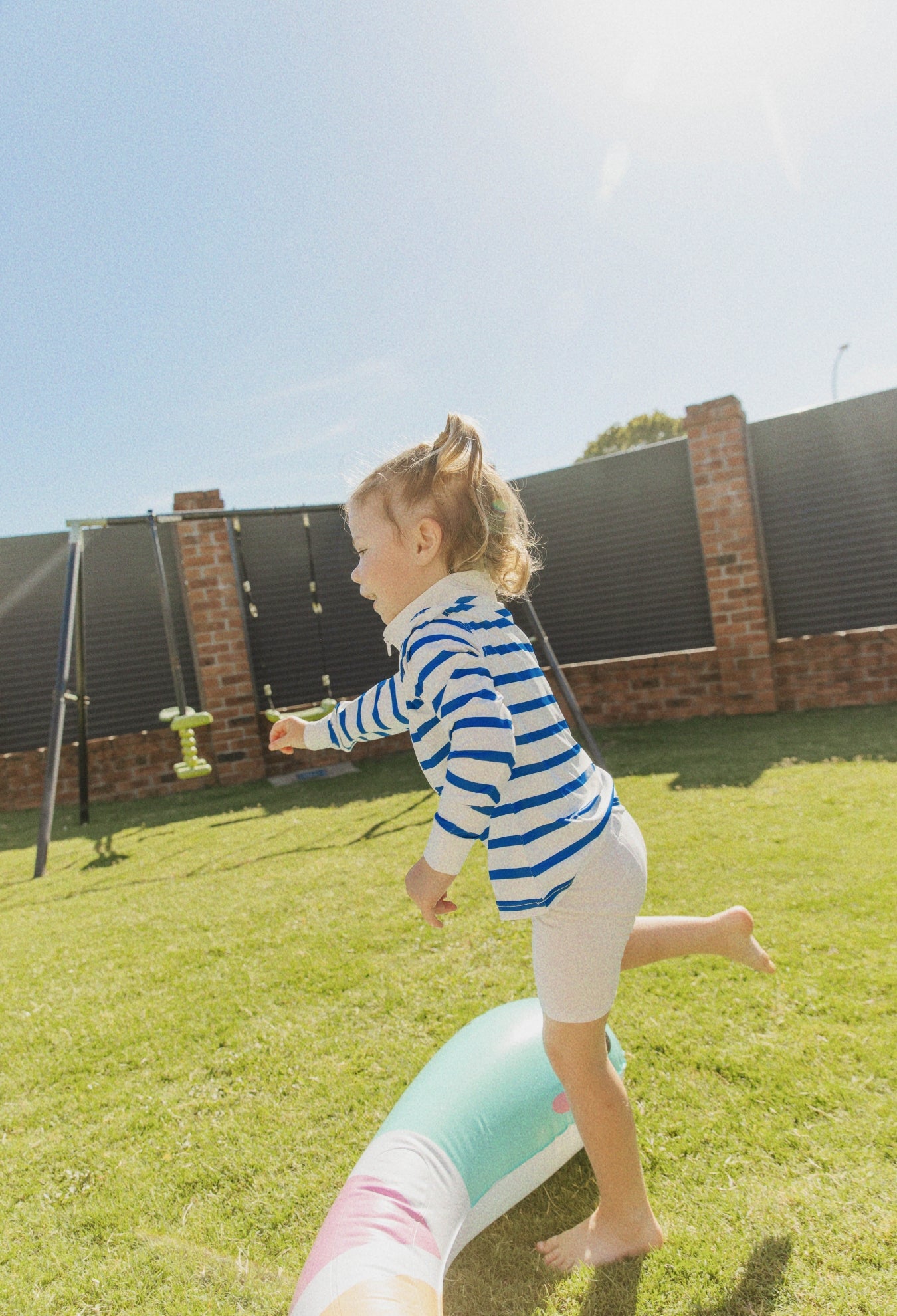 Child wearing Holiday Club Mini kids UPF 50+ sunwear shirt outdoors