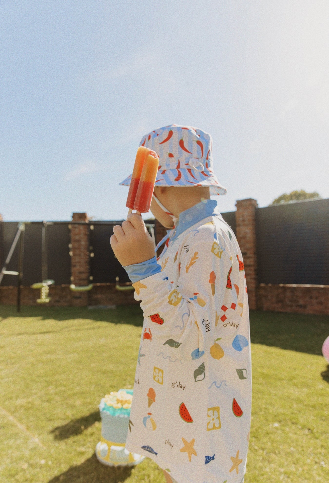 Close-up of Golden Days kids sunwear shirt showing playful summer print
