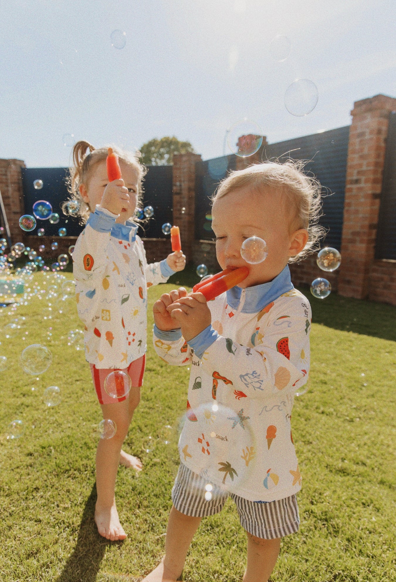 Child playing outside wearing Golden Days sunwear shirt on a sunny day