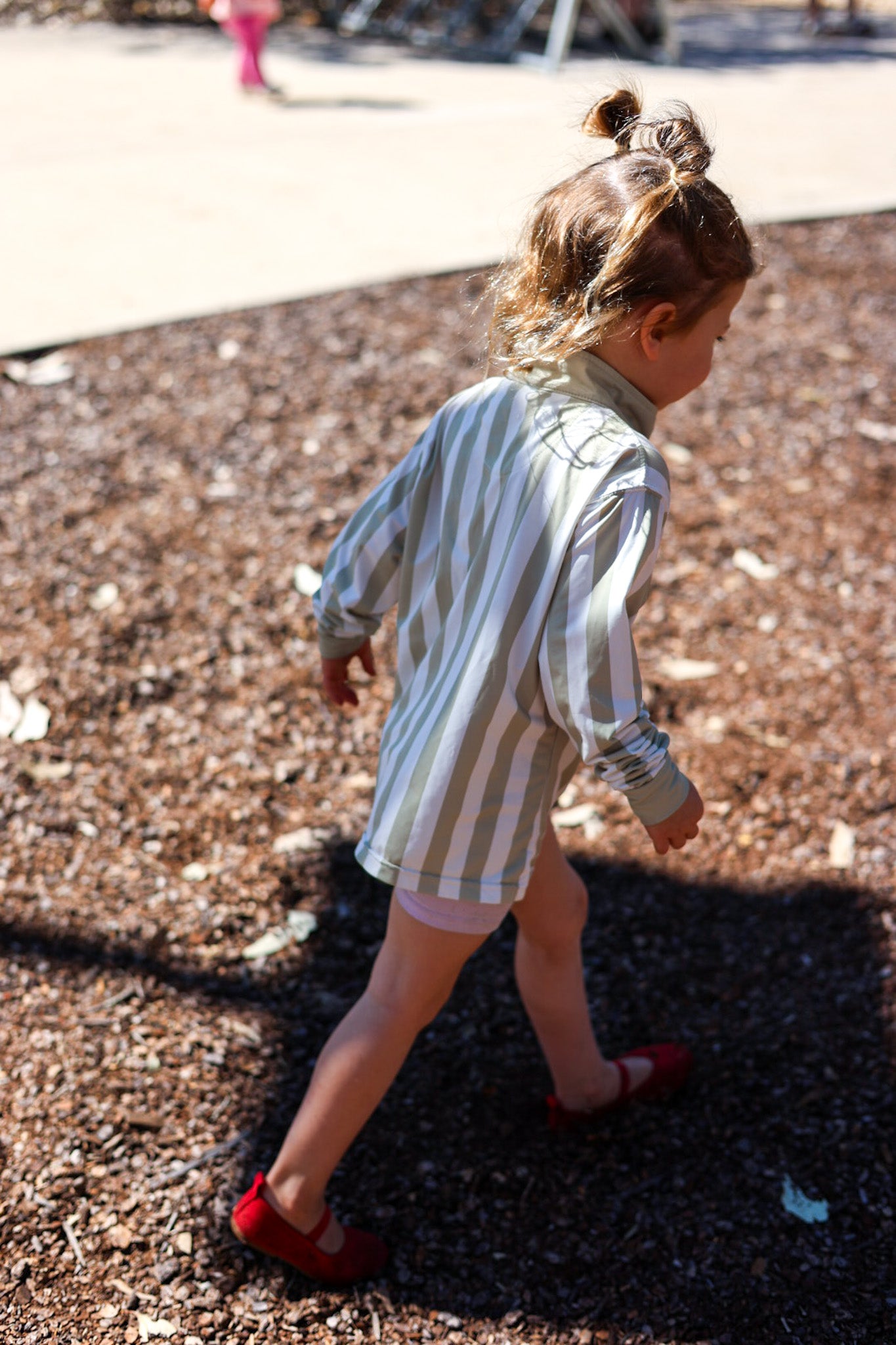 Child wearing Sol & Tide UPF 50+ kids sun shirt outdoors
