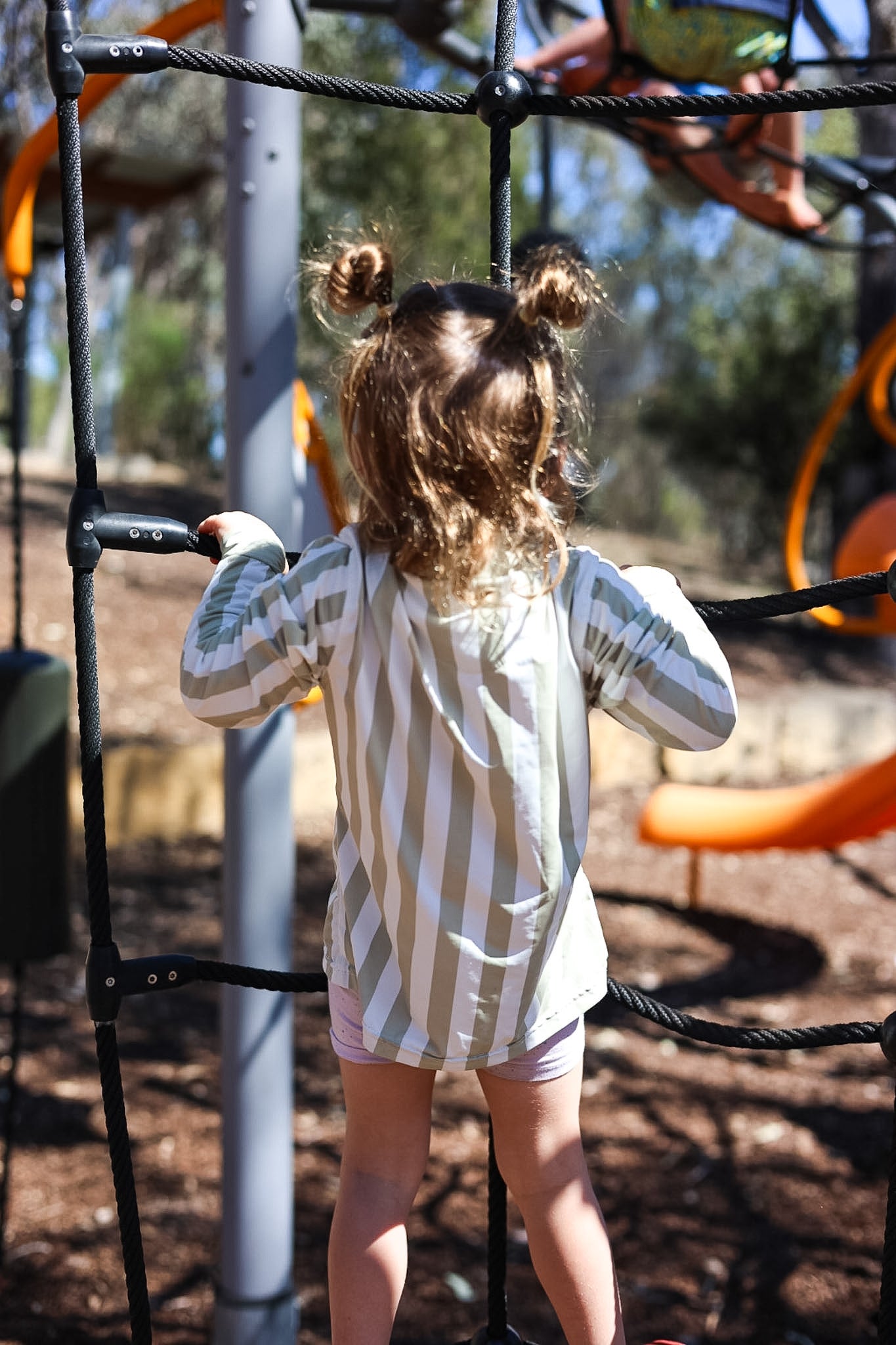 Child wearing Sol & Tide UPF 50+ kids sun shirt outdoors