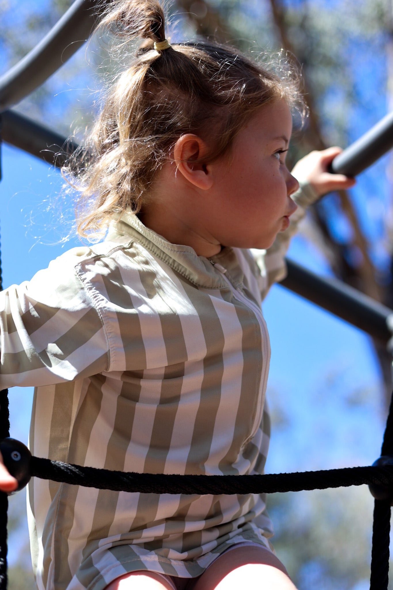 Child wearing Sol & Tide UPF 50+ kids sun shirt outdoors