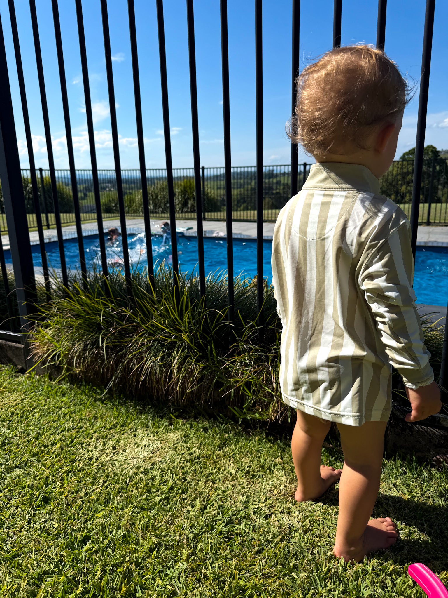 Child wearing Sol & Tide UPF 50+ kids sun shirt outdoors