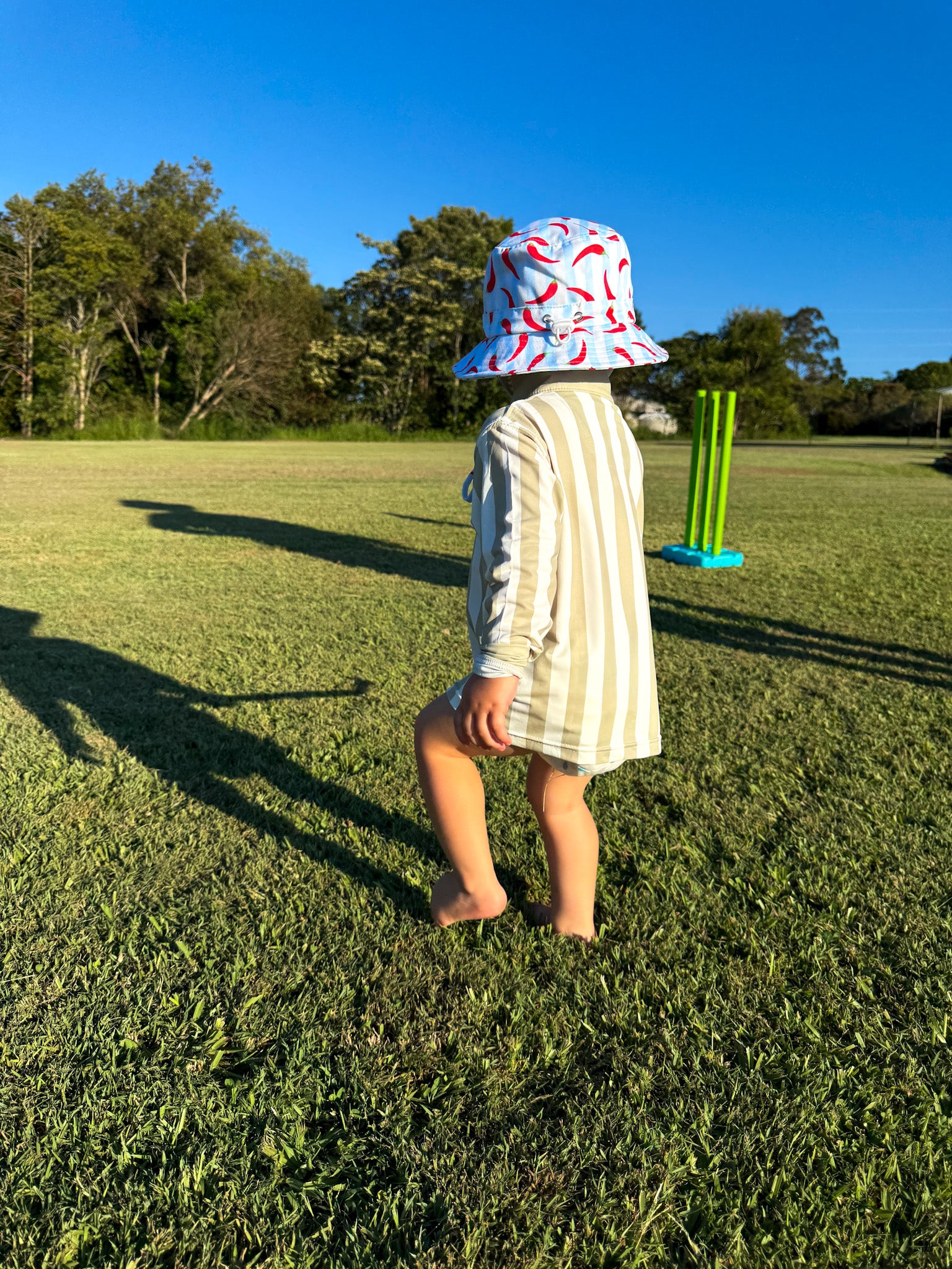 Child wearing Sol & Tide UPF 50+ kids sun shirt outdoors